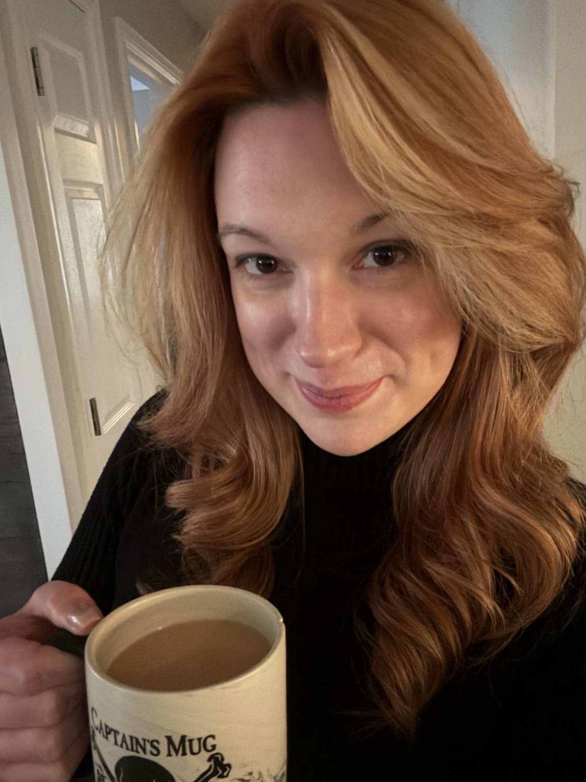 Elizabeth smiling with her morning coffee